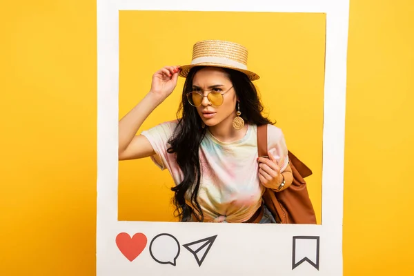 Serious brunette girl in summer outfit in social network frame on yellow background — Stock Photo