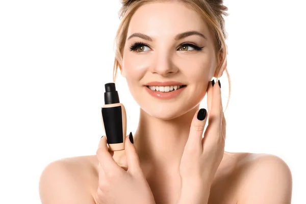 Smiling naked beautiful blonde woman with makeup and black nails holding face foundation isolated on white — Stock Photo