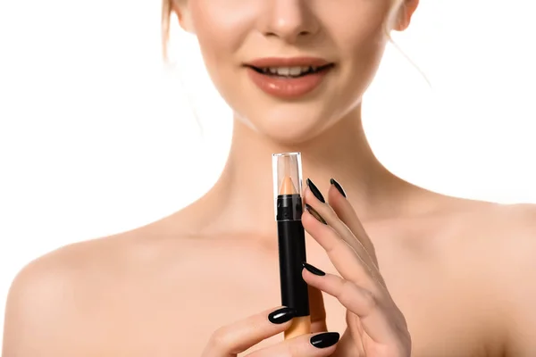 Cropped view of naked beautiful woman with black nails holding stick concealer isolated on white — Stock Photo