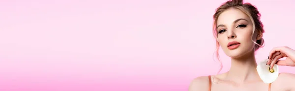 Elegant beautiful blonde woman holding calla flower on shoulder isolated on pink, panoramic shot — Stock Photo