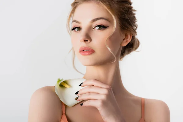 Elegant beautiful blonde woman holding calla flower on shoulder isolated on white — Stock Photo