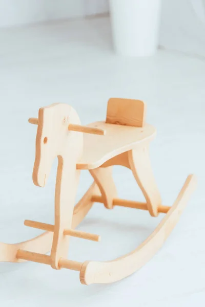 Vintage, wooden rocking horse in light room — Stock Photo