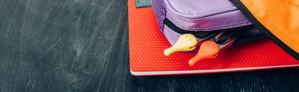 Backpack with notebook, pencil case and compass divider on black chalkboard, website header — Stock Photo