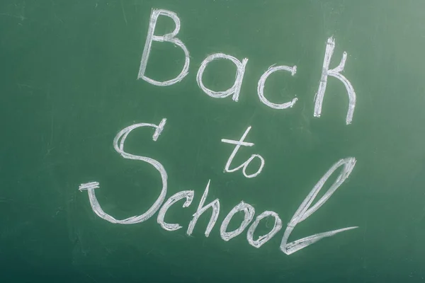 Back to school lettering on green chalkboard, top view — Stock Photo