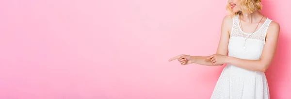 Panoramic crop of woman in white dress pointing with fingers on pink — Stock Photo