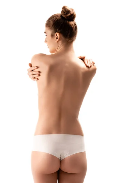 Vista posteriore della donna in mutandine in piedi e abbracciarsi isolato su bianco — Foto stock