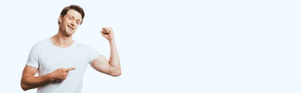 Panoramic image of man pointing with finger at muscles on arm isolated on white — Stock Photo