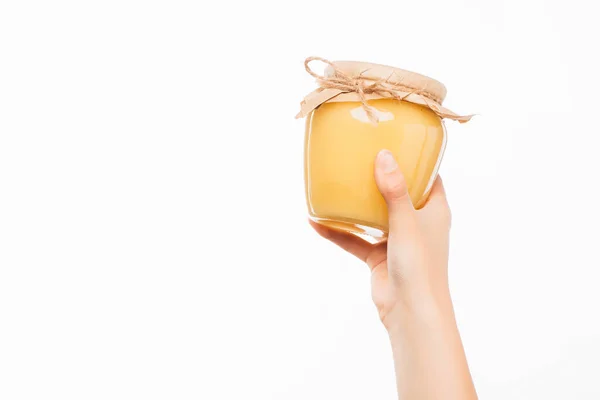 Cropped view of woman holding jar of honey isolated on white, charity concept — Stock Photo