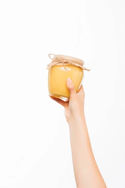 Abgeschnittene Ansicht einer Frau mit einem Glas Honig auf weißem Hintergrund, Charity-Konzept — Stockfoto