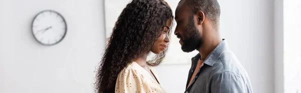 Panoramic concept of african american husband and wife standing face to face at home — Stock Photo