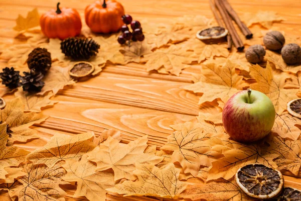 Selective focus of autumnal decoration on wooden background — Stock Photo