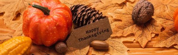 Corn, pumpkin, autumnal decoration and happy thanksgiving card on wooden background, panoramic shot — Stock Photo