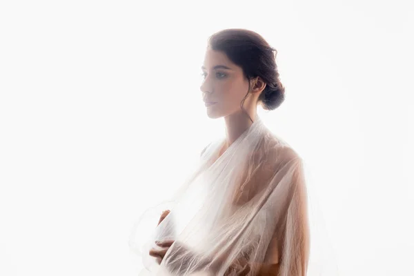Brünette Frau mit Polyethylen bedeckt, wegschauend isoliert auf weißem, ökologischem Konzept — Stockfoto