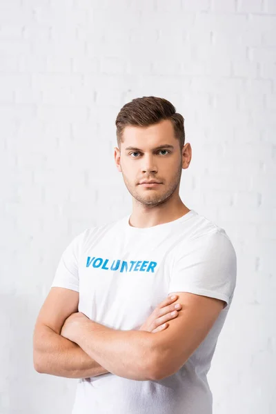 Confident volunteer with crossed arms looking at camera — Stock Photo