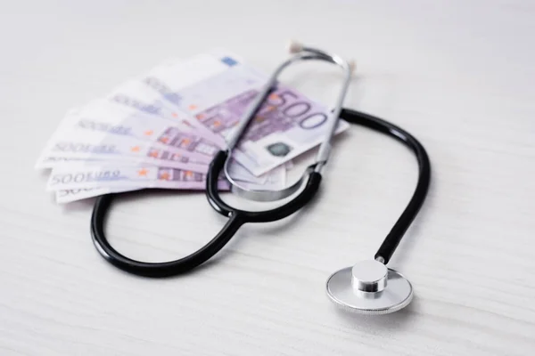 Selective focus of stethoscope with euro banknotes on table — Stock Photo