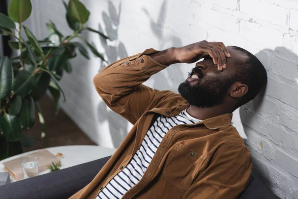 Selective focus of african american man touching face — Stock Photo