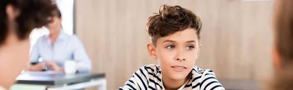 Enfoque selectivo del niño de la escuela en la cantina y el profesor en el fondo, plano panorámico — Stock Photo