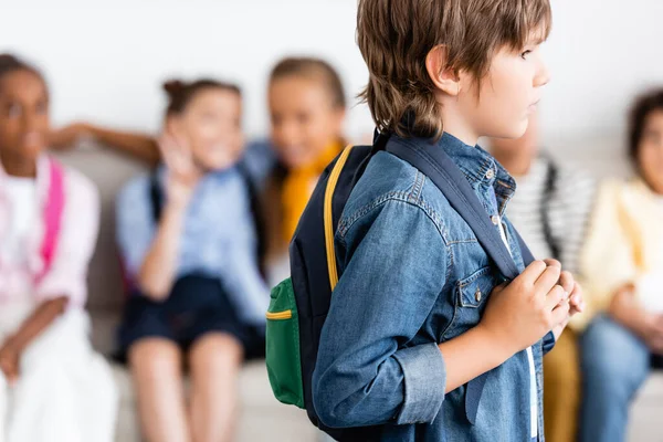 Selective focus of schoolboy with backpack standing in classroom — Stock Photo