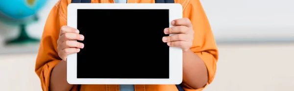 Panoramic crop of schoolboy holding digital tablet with blank screen — Stock Photo