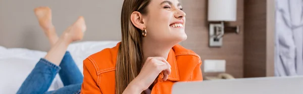 Panoramic crop of pleased and barefoot woman in hotel room — Stock Photo