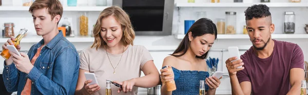 Horizontal image of multicultural friends chatting on smartphones during party — Stock Photo