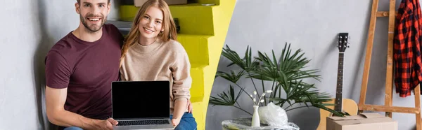 Panoramic crop of couple holding laptop with blank screen while sitting on stairs near boxes, relocation concept — Stock Photo