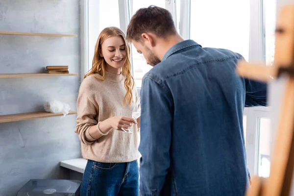 Selective focus of joyful woman holding glass with champagne near boyfriend — Stock Photo