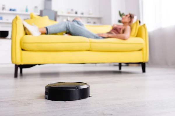 Selective focus of robotic vacuum cleaner on floor — Stock Photo