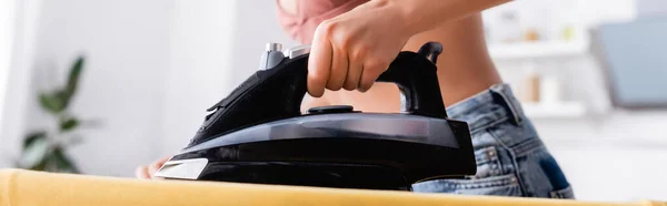 Website header of woman ironing clothes at home — Stock Photo