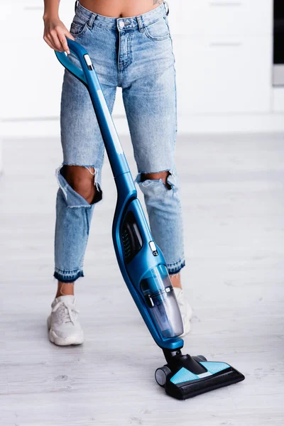 Cropped view of woman cleaning floor with modern vacuum cleaner at home — Stock Photo
