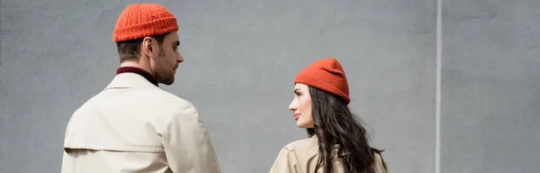 Panoramic shot of couple in autumn outfit looking at each other — Stock Photo