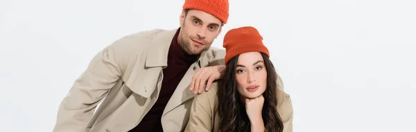 Panoramic concept of trendy man in beanie hat leaning on brunette woman isolated on white — Stock Photo