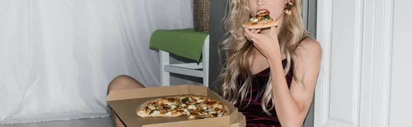 Cropped view of young blonde woman eating pizza, horizontal image — Stock Photo