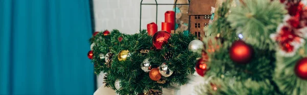 Website header of pine branches decorated with baubles and candles — Stock Photo