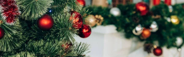 Panoramic shot of pine branches with christmas balls — Stock Photo