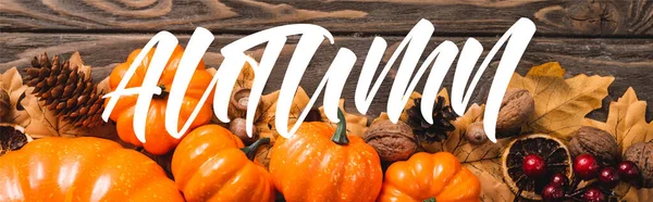 Top view of decoration with pumpkins near autumn lettering on wooden background, panoramic shot — Stock Photo