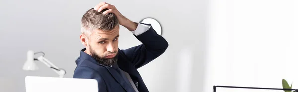 Exhausted businessman looking at laptop on blurred foreground, banner — Stock Photo