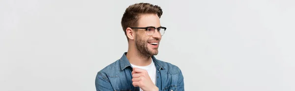 Cheerful man in denim shirt and eyeglasses isolated on grey, banner — Stock Photo