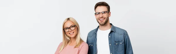 Smiling couple in eyeglasses looking at camera isolated on grey, banner — Stock Photo