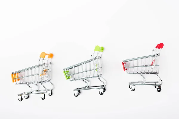 Top view of small shopping carts on white background — Stock Photo