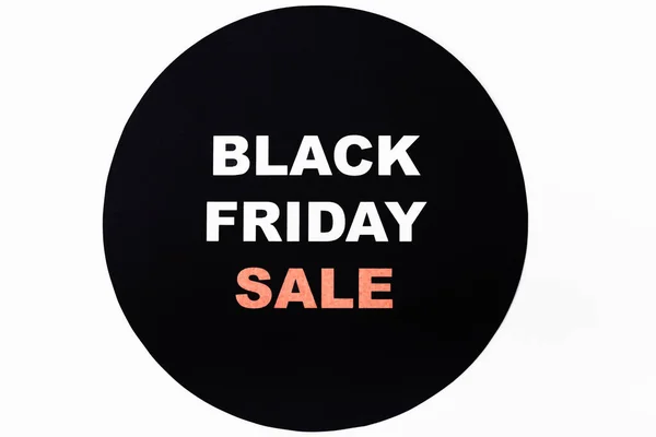 Top view of black friday sale lettering on black circle on white background — Stock Photo