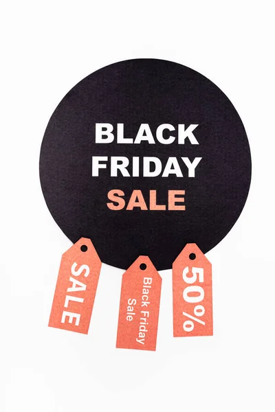 Top view of black circle with black friday lettering near price tags on white background — Stock Photo