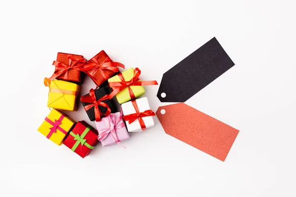 Top view of toy gifts and empty price tags on white background — Stock Photo