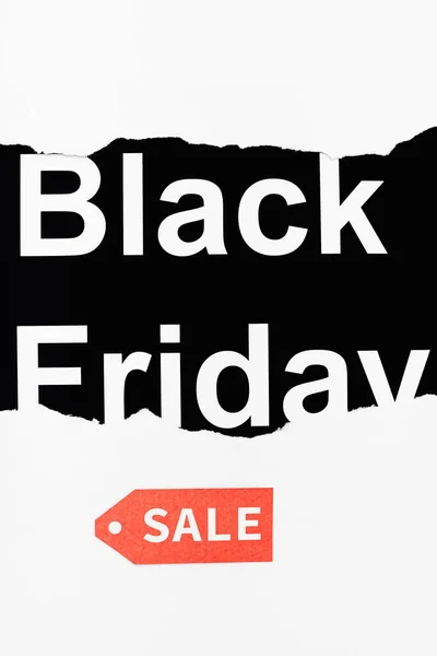 Black friday lettering and red price tag on black and white background — Stock Photo