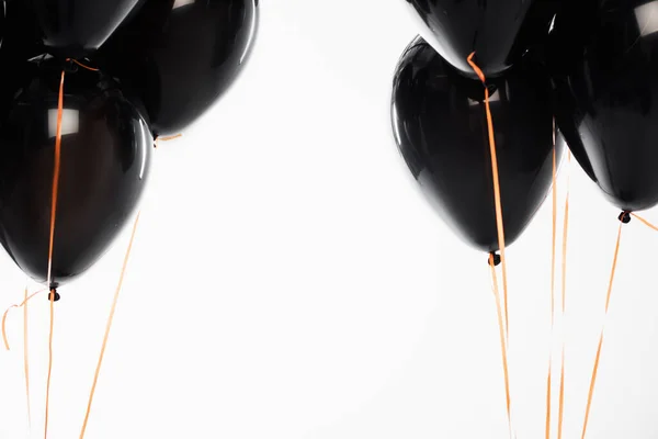 Black festive balloons with strings isolated on white — Stock Photo