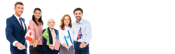 Positive multicultural businesspeople holding flags of countries isolated on white, banner — Stock Photo