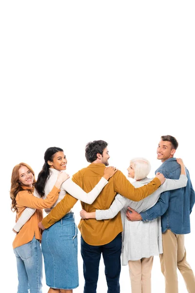 Multicultural friends smiling while hugging each other isolated on white — Stock Photo