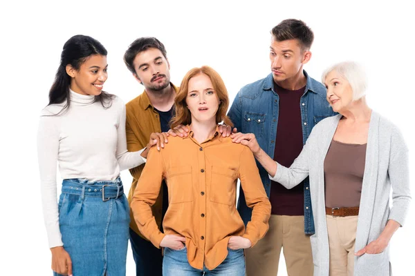 Skeptical woman looking at camera near multiethnic friends isolated on white — Stock Photo