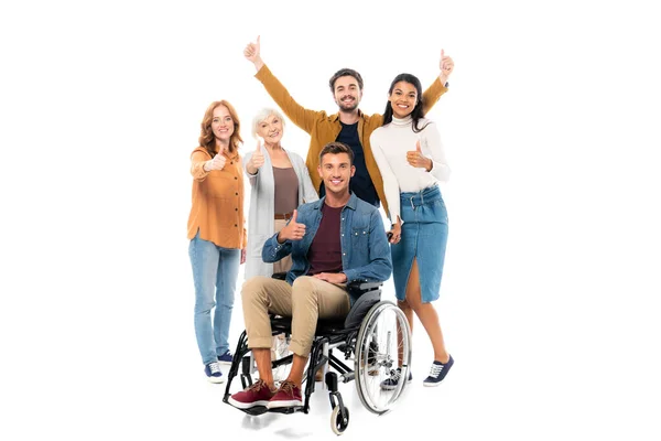 Smiling multiethnic people showing like near man in wheelchair on white background — Stock Photo