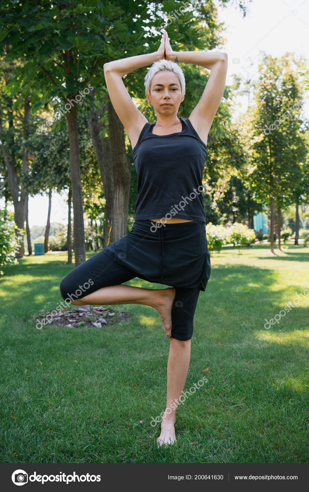Woman Practicing Yoga Tree Pose Vrksasana Looking Camera Grass Park Stock  Photo by ©ViktoriaSapata 200641630